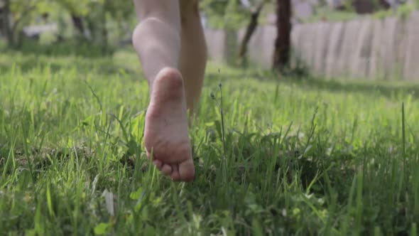 Baby Feet Running In The Grass