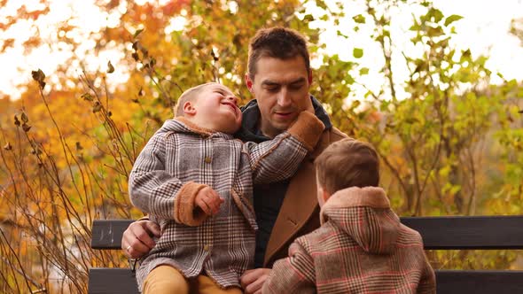 Handsome Caucasian father having fun with his adorable children in autumn