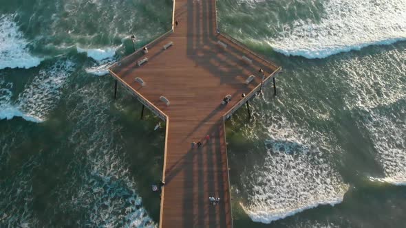 Pismo Beach Pier Drone Tilt with Surfers and Waves Crashing