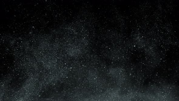 Super Slow Motion Shot of Silver Glittering Particles Isolated on Black Background at 1000 Fps alt