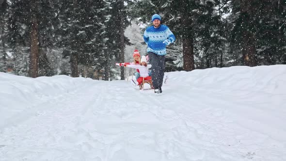 Happy Family Having Fun Outdoor. Child, Mother And Father Playing In Winter Time