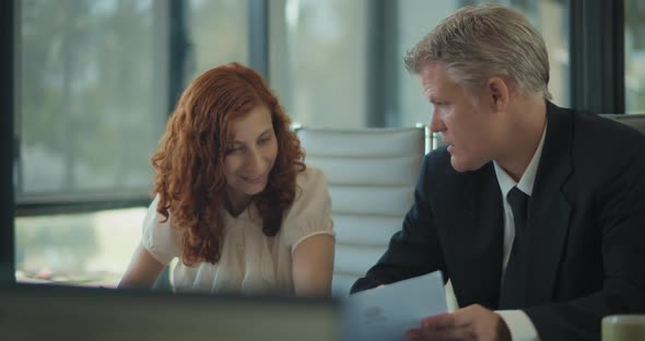 Two business people making notes during a business meeting in the office room. Slow motion alt