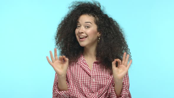 Slow Motion of Beautiful Young Woman with Dark Curly Hair Showing OK Signs Saying Yes Okay and