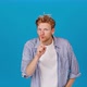 Young Redhead Man Puts Finger to Lips Showing Silent Gesture - VideoHive Item for Sale