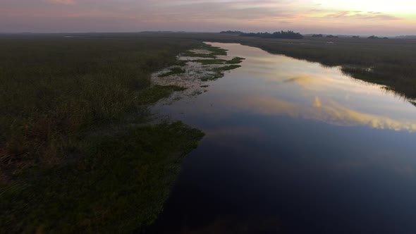 A tranquil twilit sky reflects on water in the Ibera Wetlands, Corrientes Province, Argentina alt