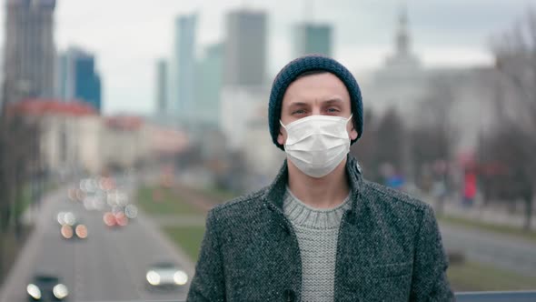 Portrait of Man in Surgical Face Mask in City, SARS-CoV-2 Coronavirus Outbreak