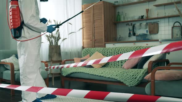 A Person in Protective Suit Disinfects House During Pandemic alt