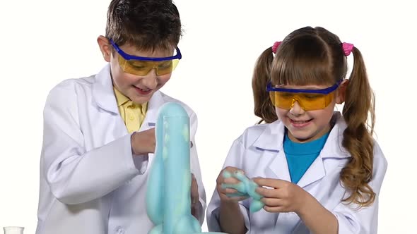 Two Cute Chemist Children Making Interesting and Successful Experiments with Blue Foam, Playing alt