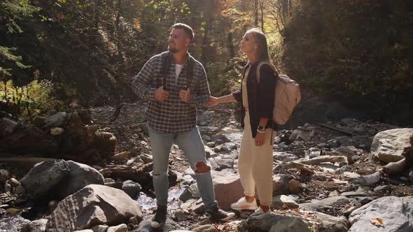 Loving Pair is Exploring Forest at Autumn Hiking at Nature alt