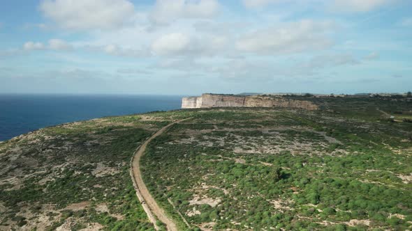 AERIAL: Revealing Steep Slopes of Ta Cenc Cliffs on a Windy Winter Day in Gozo Island
