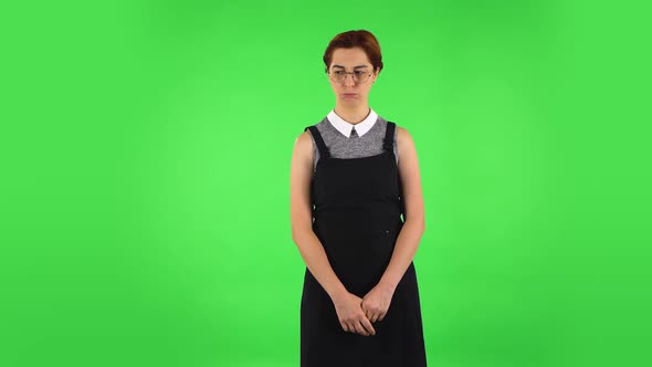Funny Girl in Round Glasses Is Very Offended and Looking Away. Green Screen alt