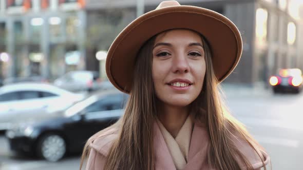 Close up portrait of Charming long hair young woman in a coat and round hat alt