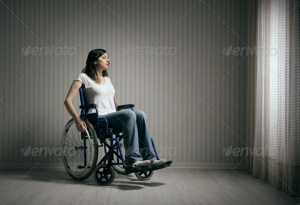Sad woman sitting on wheelchair - Stock Photo - Images