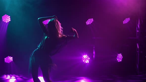 Silhouette of a Slender Woman Dancing Rumba Elements alt