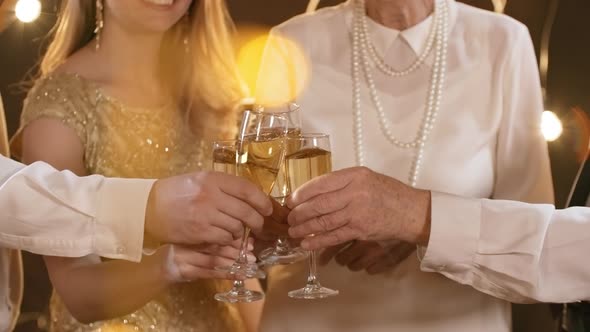 Unrecognizable People Clinking Glasses at Christmas Party alt
