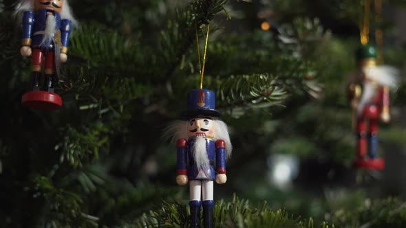 Nutcracker Soldier Toy on a Christmas Tree With Blurred Background Dolly 4K Shot. alt
