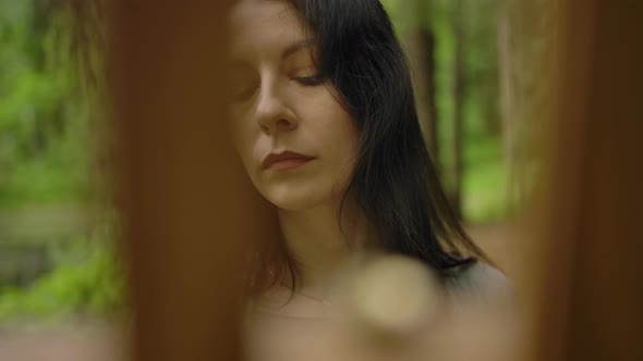 General Wide Shot of a Cute Artist Painting a Landscape on an Easel in the Forest. alt