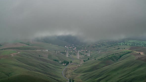 8K Bridge on Intercity Highway in Valley Under Storm Clouds