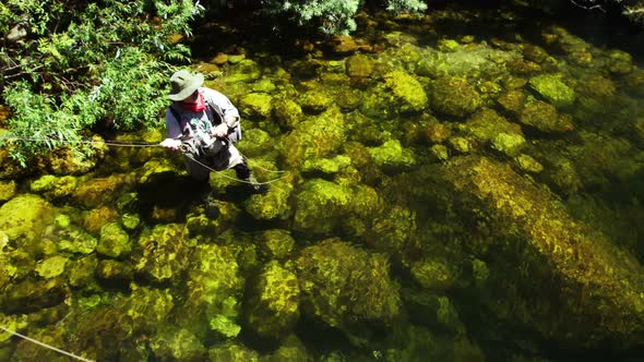 Fisherman fly fishing in river alt
