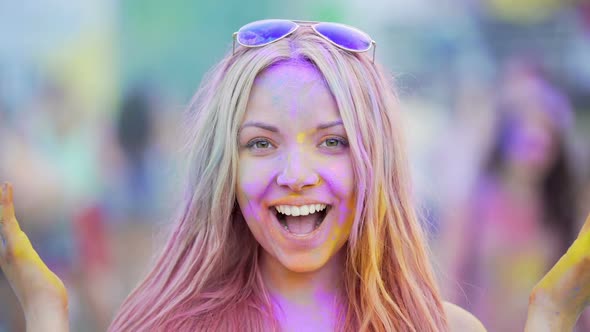 Young Woman Making Funny Faces, Dancing to Music at Concert, Smiling to Camera alt