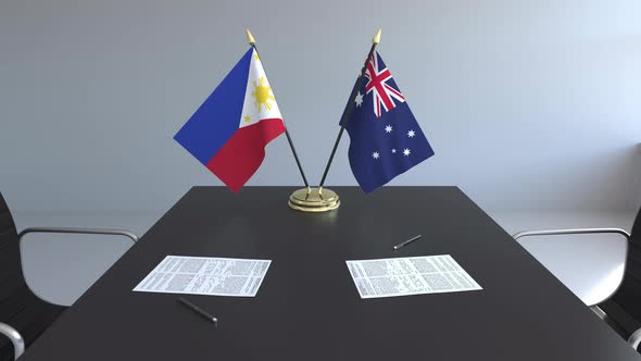 Flags of the Philippines and Australia and Papers on the Table alt