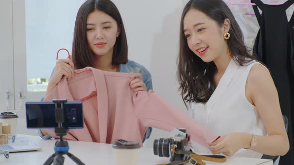 Female friend sell clothing design entrepreneur is using laptop to present communicate to client alt