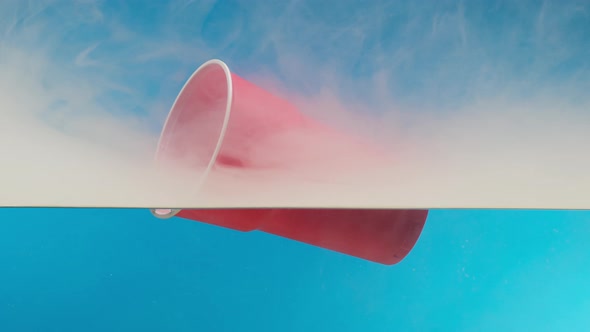 Plastic Trash Glass Floating in Ocean with Smoke Water Pollution Concept alt