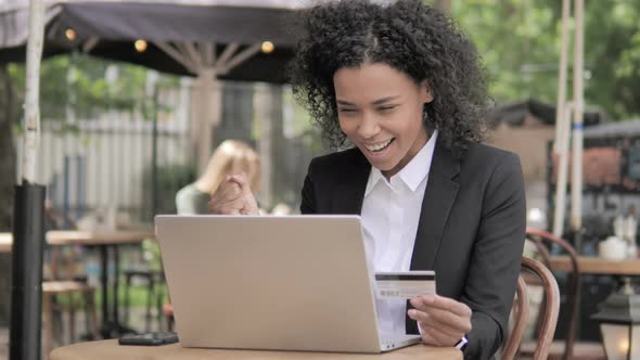 Successful Online Shopping by Young Woman Sitting on Bench alt