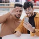 Two Young Arab Guys Friends Looking at Screen Talking on Webcam Using Mobile App on Phone Blogging - VideoHive Item for Sale