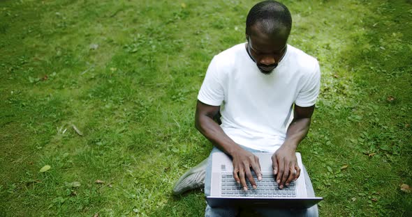 African-american Student Typing on Laptop Top View