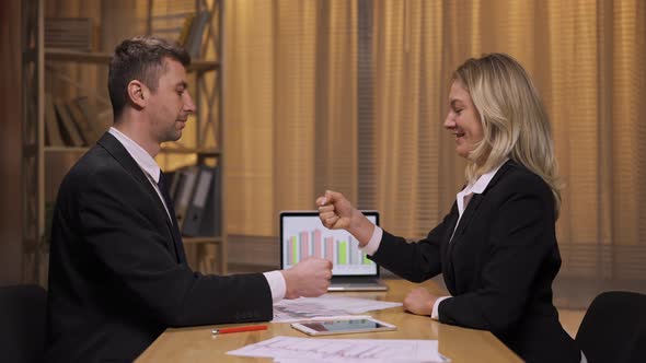 Business Partners Analyze Stock Market and Team Strategy in an Office Meeting alt