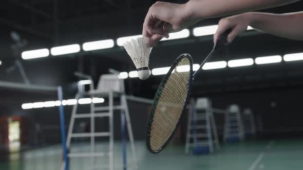 Hands of Sportsman Holding Racket and Shuttlecock alt