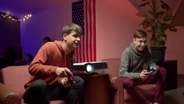 Cheerful Gamers with Joysticks Playing Video Game