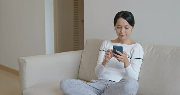Woman use of smart phone at home alt