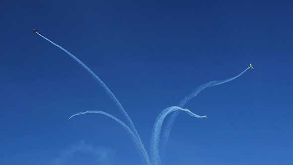 Airplanes Doing Tricks on Blue Sky Background 7