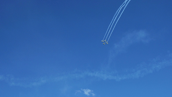 Airplanes Doing Tricks on Blue Sky Background 4