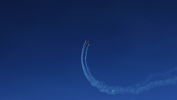 Airplanes Doing Tricks on Blue Sky Background 3