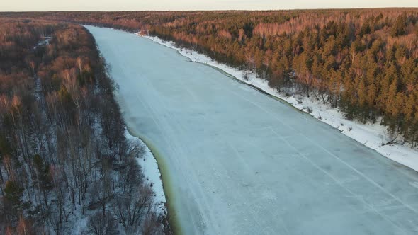 Spectacular Winter Landscape with Frozen River at Sunset Aerial View alt