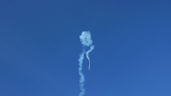 Airplane Doing Tricks Against Blue Sky