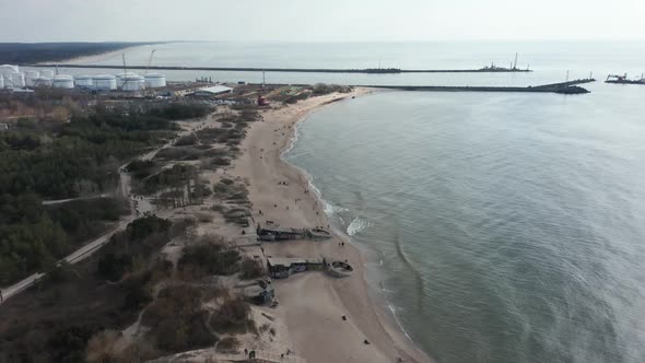 AERIAL: Sandy Beach of Melnrage in Klaipeda with Port Visible in Distance