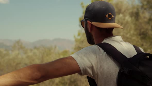 Man Looking Into Distance At Sea. Man In Sunglasses Stay On Cliff On And Looking At Sea. alt