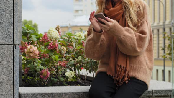 Beautiful Girl Sitting in City Street with Shopping Bags Female Shopper Make Online Order Shake Head alt