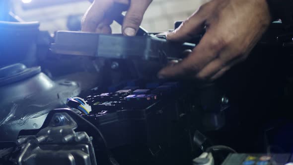 Male Mechanic Checking and Repair the Engine in Car Service alt