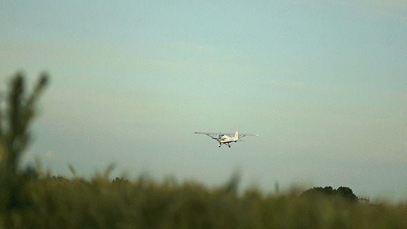 Airplane Flying Over Field
