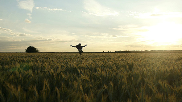 Men Running Through Wheat Field 1