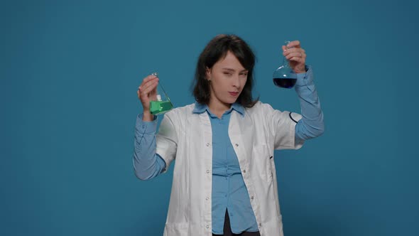 Woman Chemist Analyzing Genetic Substance in Lab Beakers alt