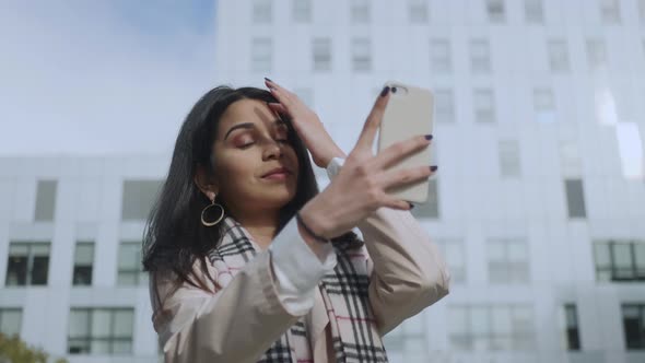 Businesswoman Taking Selfie on Smartphone at Street. Girl Using Mobile Phone alt