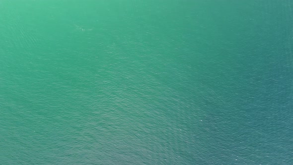 Aerial Panoramic View of Seascape with Crystal Clear Azure Sea and Rocky Shores alt