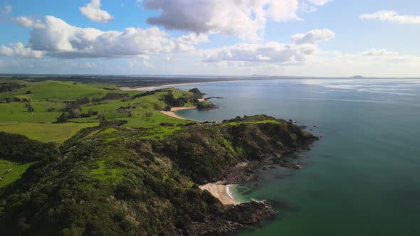 Flying backwards over Coopers Beach in New Zealand's North Island alt