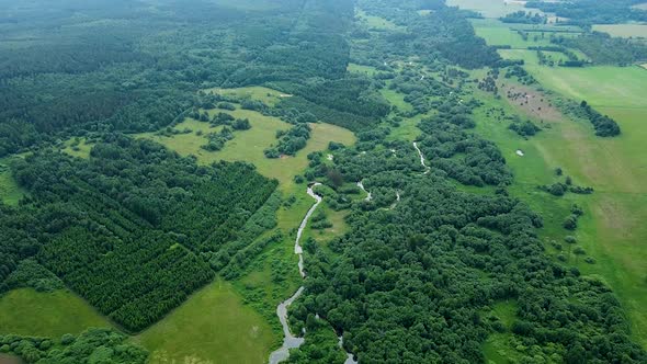 Beautiful aerial birdseye view of Sventaja river in sunny summer day, wide angle high altitude drone alt